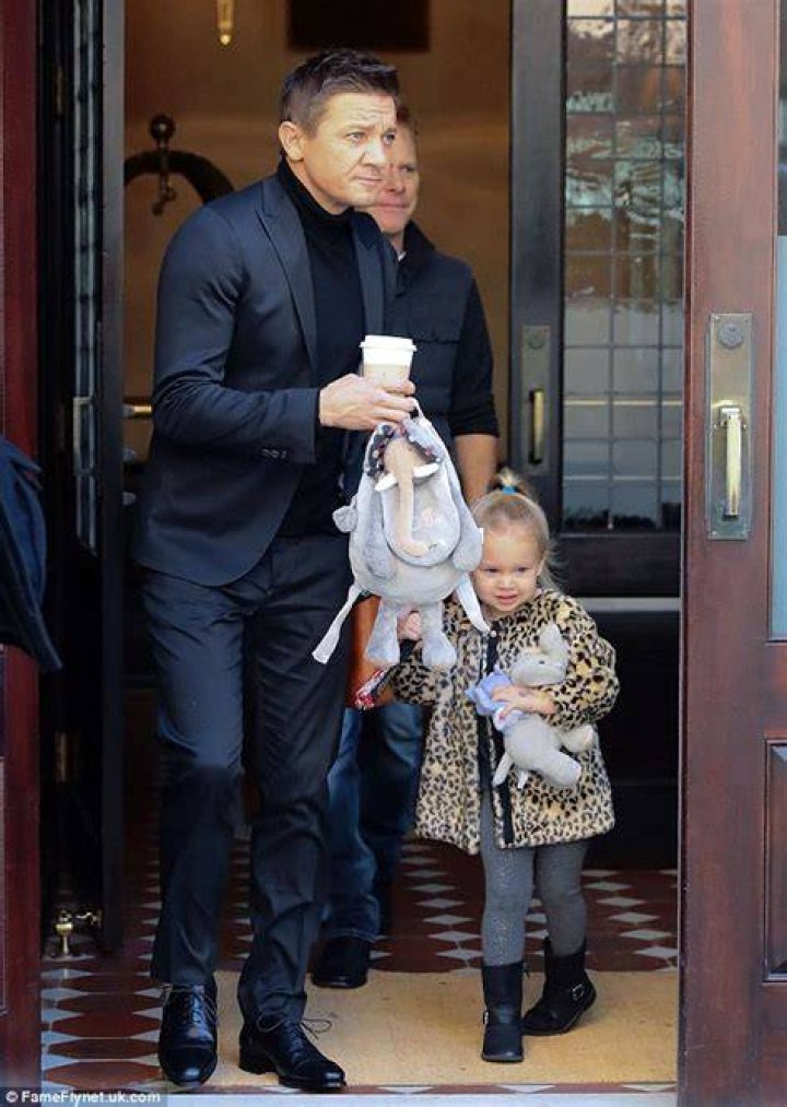 Jeremy Renner holds his threeyearold daughter Ava's hand as they